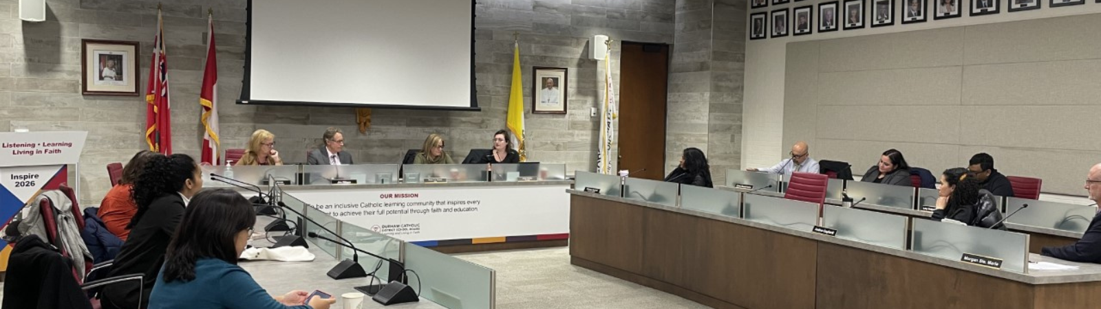 Group of adult men and women in a meeting in a boardroom