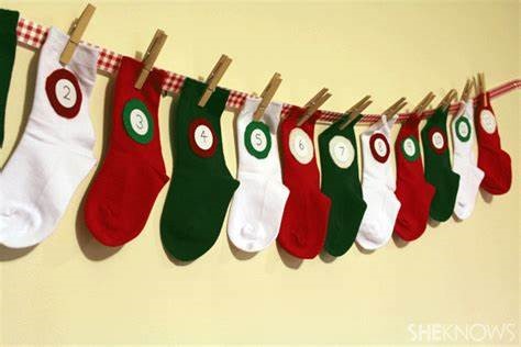 Socks hung up on a wall with a number for each day of Advent