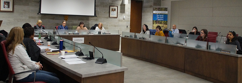 Male and women meeting in a boardroom