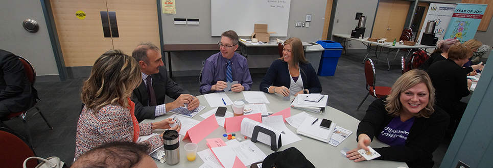 Male and female adults talking at a table