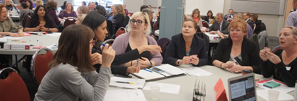 Six female adults talking at a table